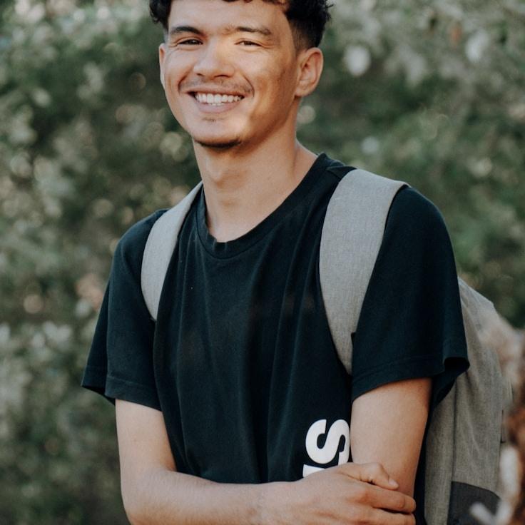 Ariana Weiss, Lead Design Curator at Meadow Packet Trail, reviewing corporate floral arrangements